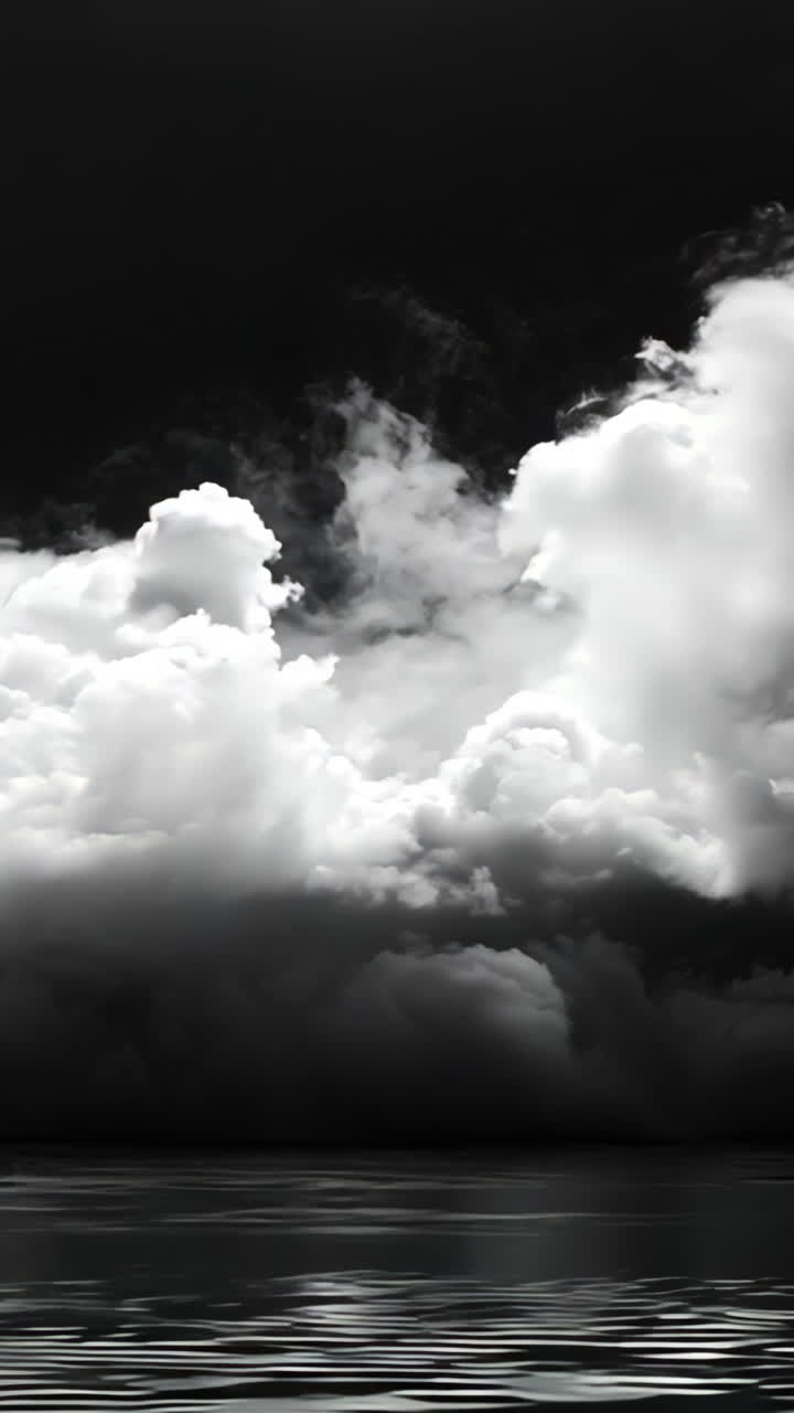 A black and white photo of a cloudy sky with smoke in the background. Scene is somber and mysterious