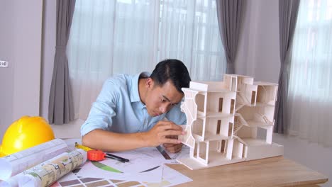 male architect hands making model house