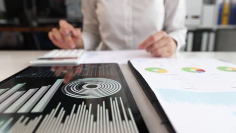 hand woman holding pen pointing to summary report chart and calculating finance