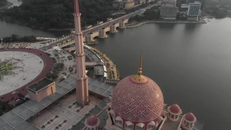 Tilt-down-shot-of-big-Putra-mosgue-at-Putra-jaya-Malaysia,-aerial