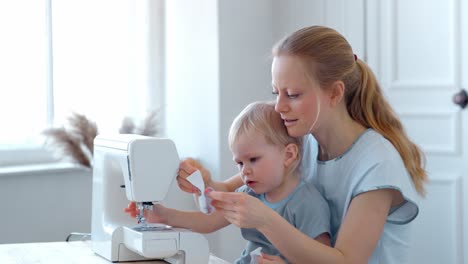mother and child sewing together