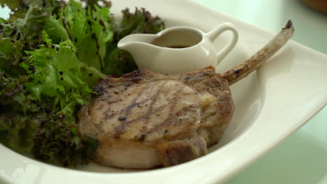 pork steak with salad on plate