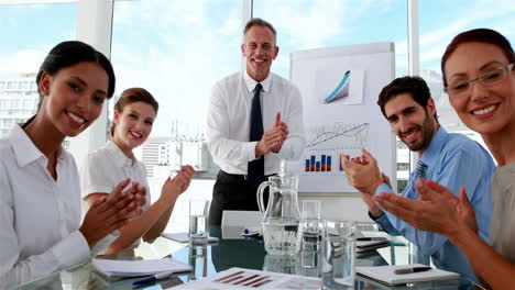 Business-manager-applauding-his-staff-at-meeting