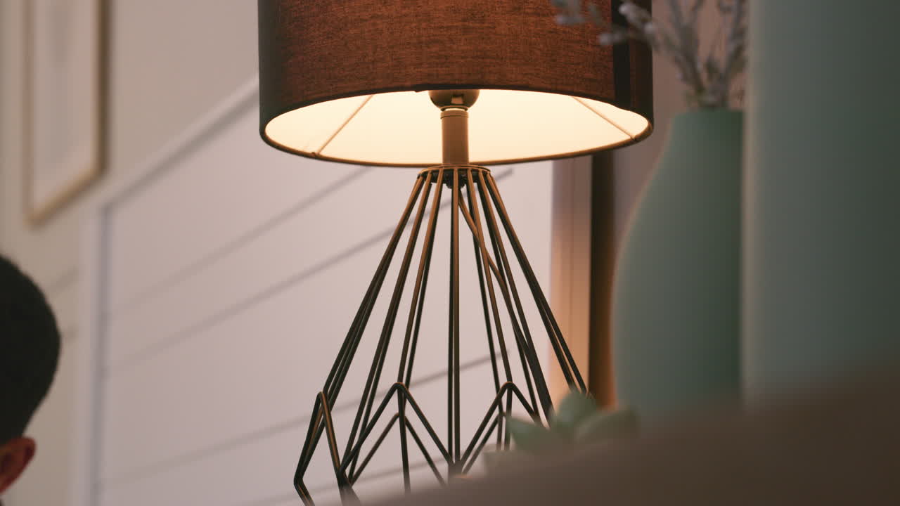 Person near table lamp