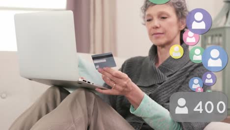 animation of media icons over caucasian woman using laptop