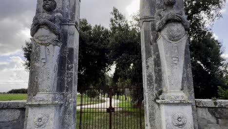 Mammalocchi-busts-travertine-columns-with-allegorical-figures-standing-at-entrance-to-private-villa-in-Umbria,-Italy