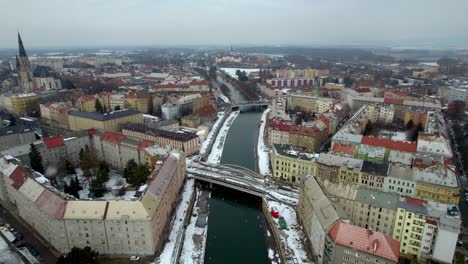 aerial view of the city of olomouc in moravia in the czech republic with falling snow in winter