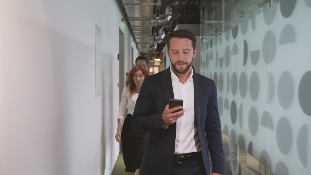 A young work team walking through the corridors of an office building