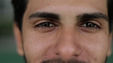 closeup of mixed-race mans eyes looking at camera, talking