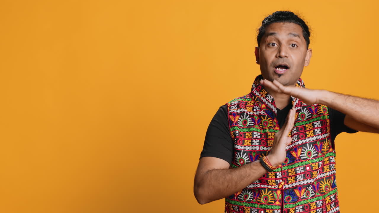 Firm person doing vehement pause sign gesturing, studio background