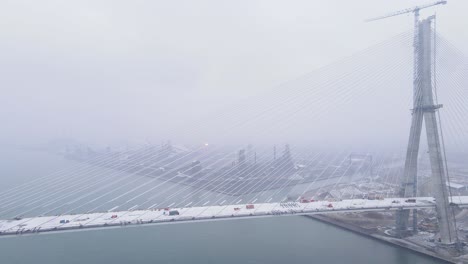 snowstorm over gordie howe bridge with zug island in background