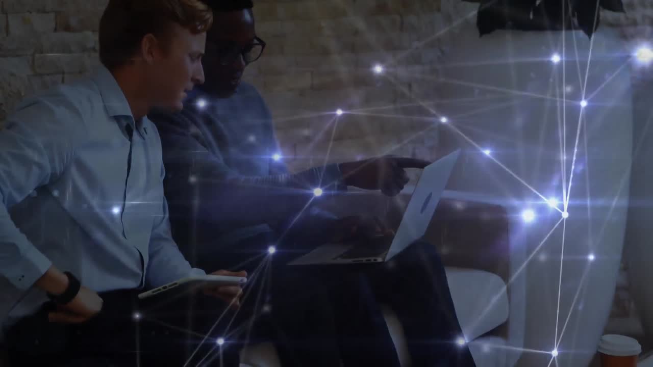 Glowing network of connections against office colleagues using electronic devices