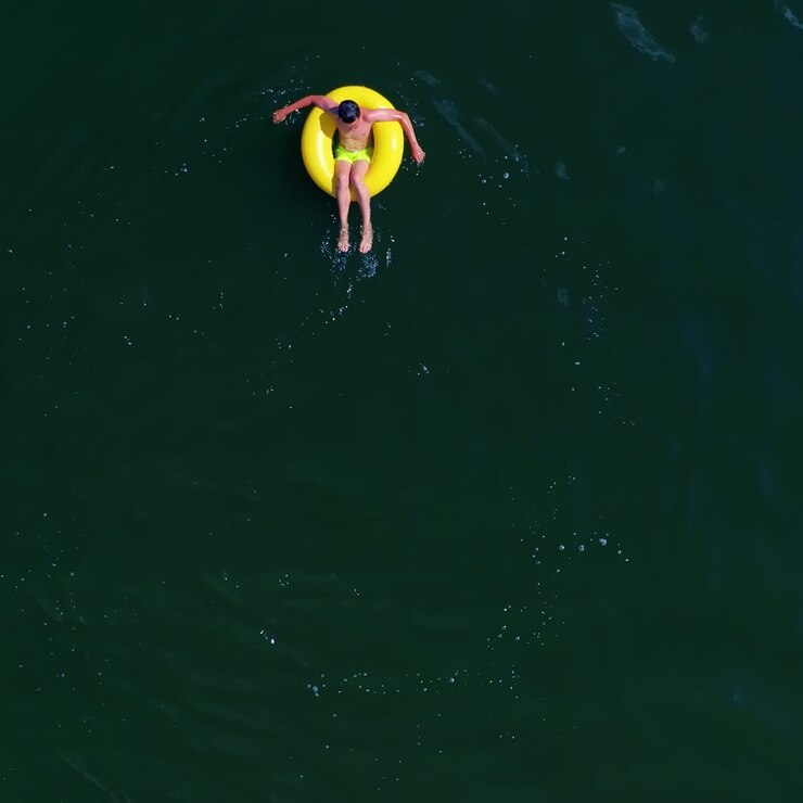 Boy swimming on pool ring