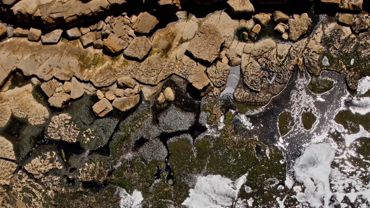 Aerial view of rocky coastline in Portugal at low tide near the shore