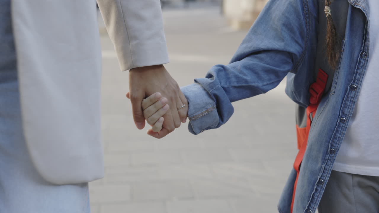 Mother and Daughter Walking Hand-in-Hand