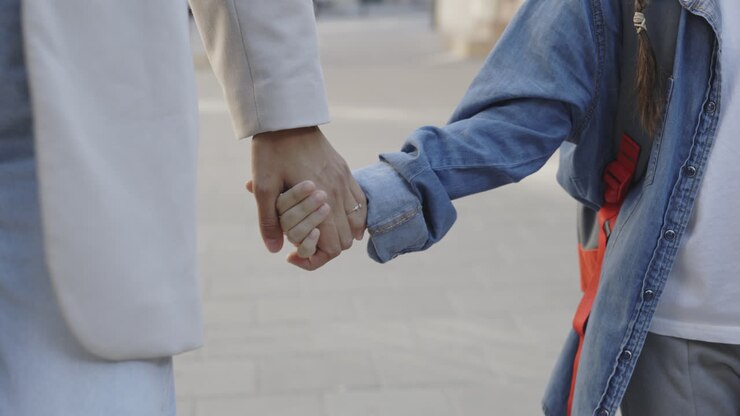 Mother and Daughter Walking Hand-in-Hand