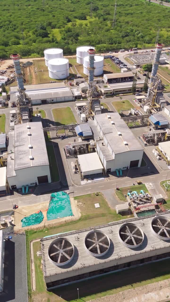 Large industrial fans on cooling tower at Energa 4 power generation plant in San Pedro de Macoris, Dominican Republic. Aerial dorne orbiting, vertical format