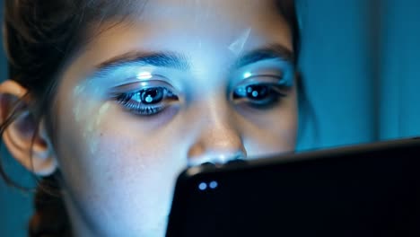 girl using a tablet in blue light