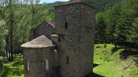 circular drone view of a mountain church in the pyrenees