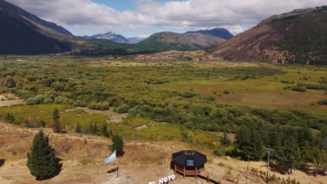 scenic fields and mountains in el hoyo village in argentina - aerial drone shot