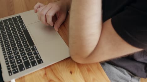 Close-up-Young-Man-Freelancer-Hand-Using-Laptop,-Trackpad,-Touchpad,-Scrolling,-clicking,-Surfing-Web-on-table-during-the-day