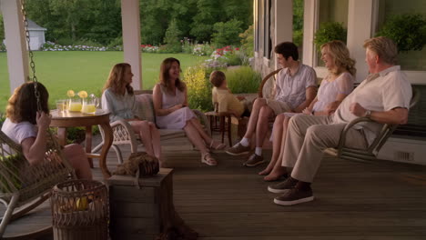 family relaxing and socializing on a summer porch