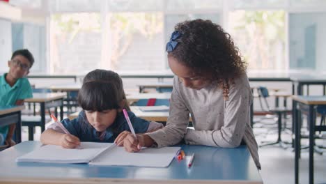 Focused-African-American-and-Latin-primary-school-girls-drawing-on-notebook