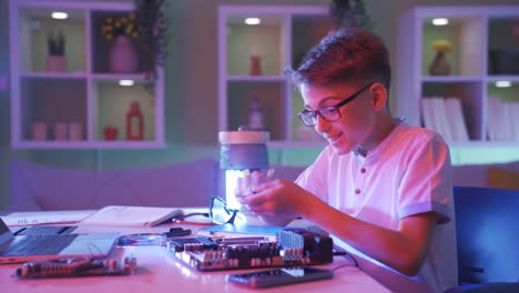 little boy trying to fix the electronic board. technology enthusiast.