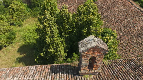 abandoned italian villa with overgrown greenery and old tiled roof seen from above