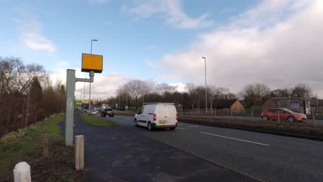 cars travel past a speed camera near the city centre, slowing down as they pass the camera, safe driving