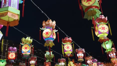 chinese colorful lanterns, which symbolize prosperity and good fortune, hang from a wire during the mid-autumn festival, also called mooncake festival