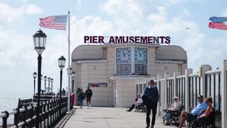 people walking and relaxing on worthing pier