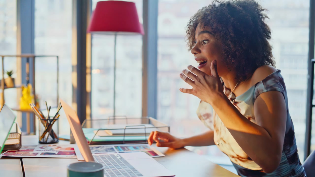Excited business man woman celebrating success on laptop, coworkers cheering