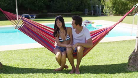 loving couple in hammock kissing each other