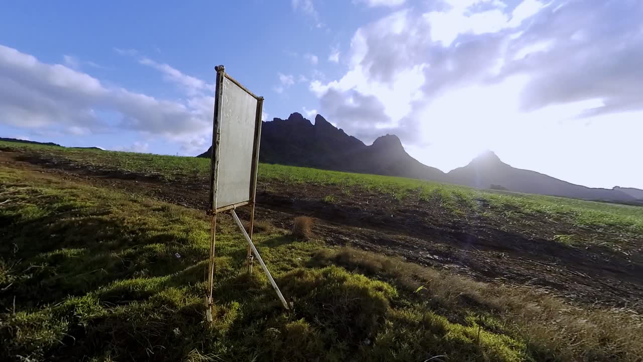 Majestic Mountain Landscape with Field and Blank Sign