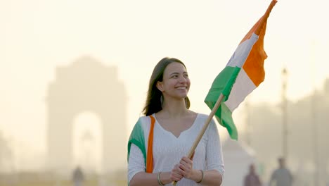 proud indian girl looking towards indian flag at the celebration of independence day at india gate delhi