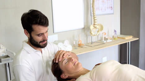 physiotherapist giving head massage to a female patient