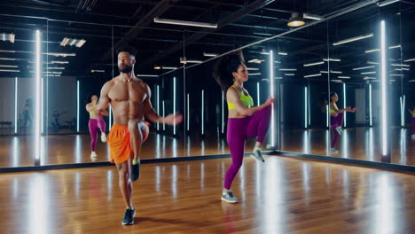 couple dancing zumba in gym