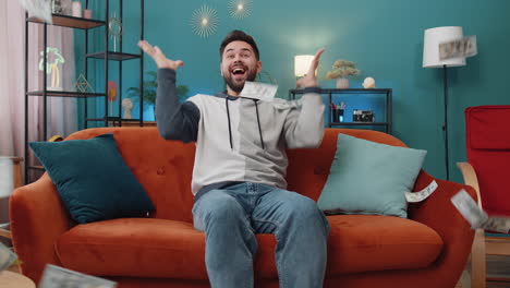 money cash dollar rain falling on man celebrating success winning good news lottery jackpot luck