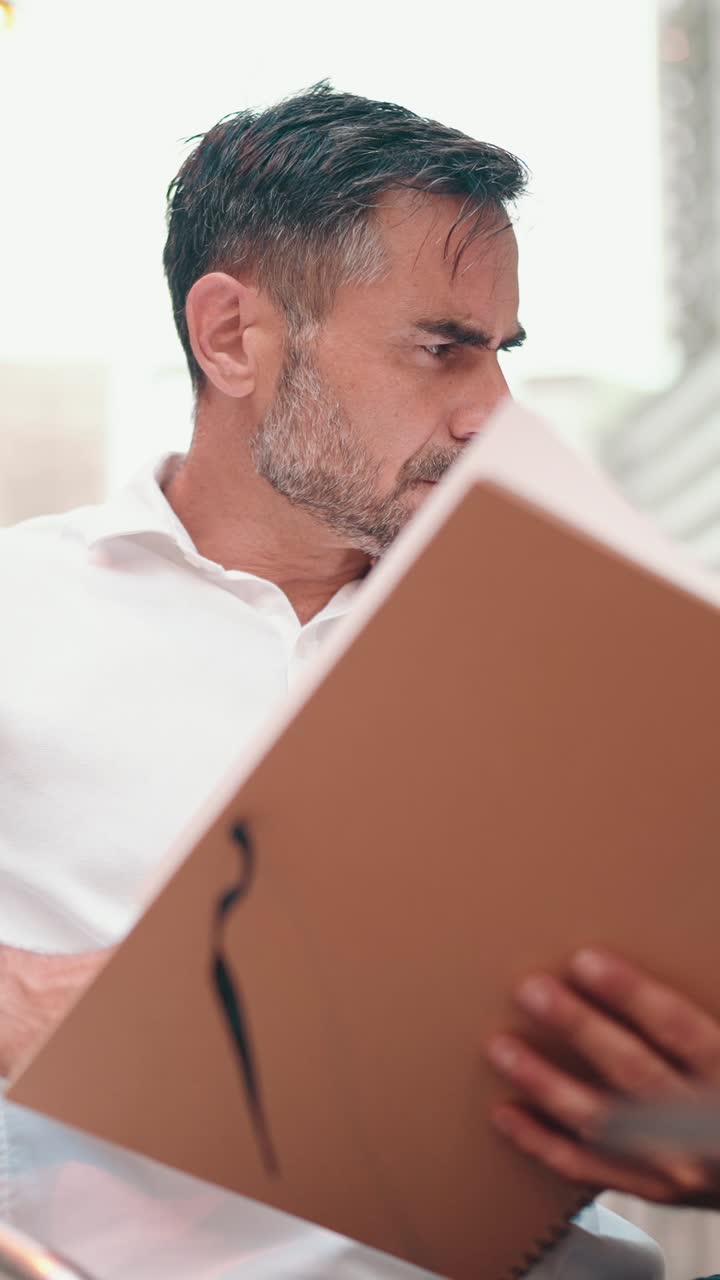 Man reading a book indoors