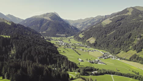 aerial over picturesque tyrolean countryside with forest covered mountains and grassy fields-2