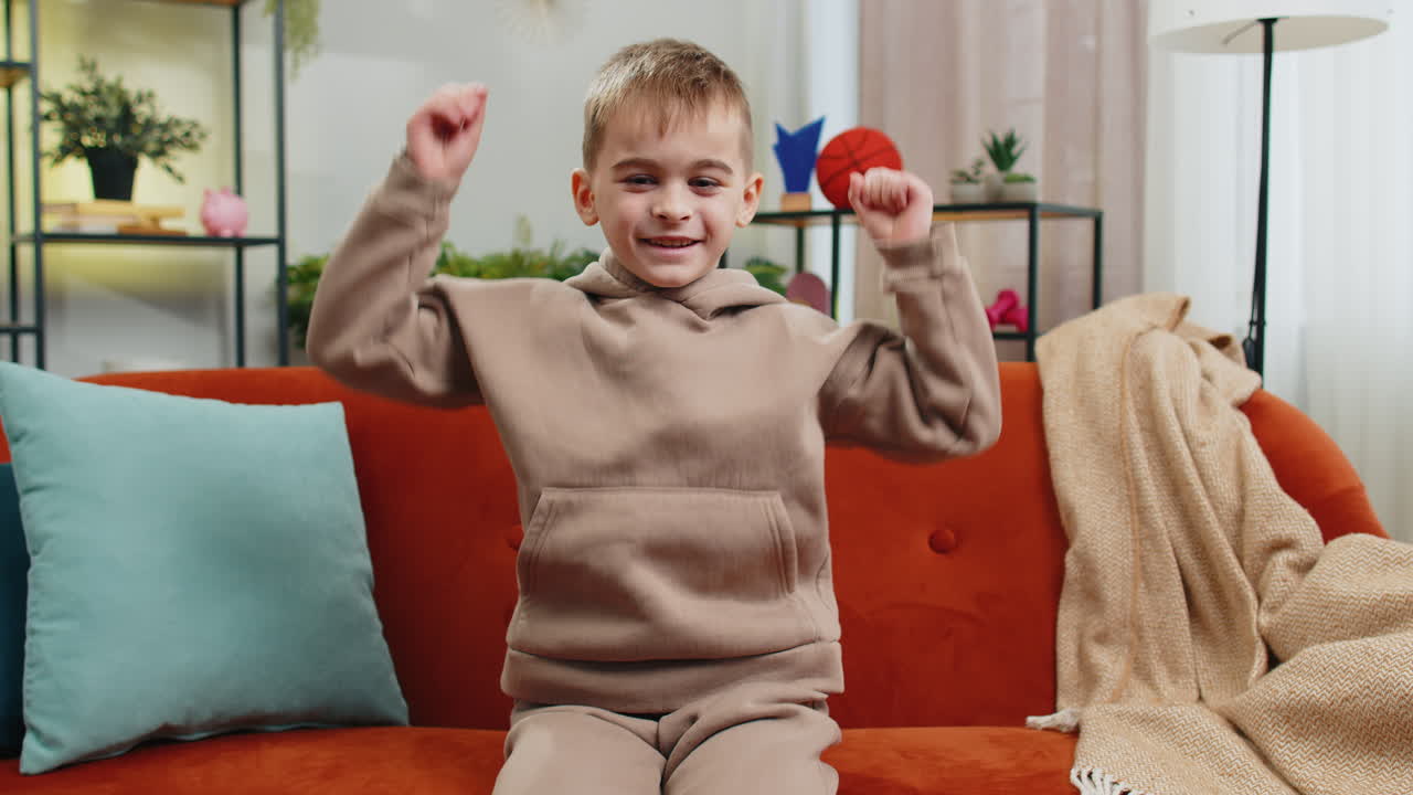 Excited child boy surprised shocked by sudden victory good win news celebrating wow reaction