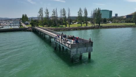 Brisbane-Marina,-fisherman-on-Pier