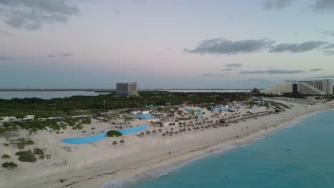 cancun beach with turquoise waters, resorts, and tropical scenery at sunset, aerial view, playa delfines