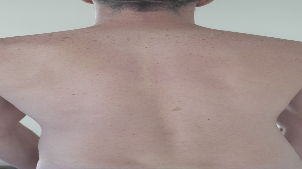 fotografía vertical de un atleta masculino posando y mostrando sus músculos de la espalda