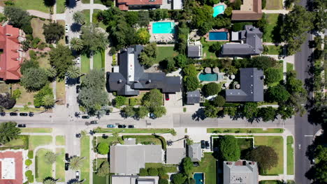 drone flying over palm tree, mansion and pool dotted neighborhood in beautiful west hollywood, los angeles, california