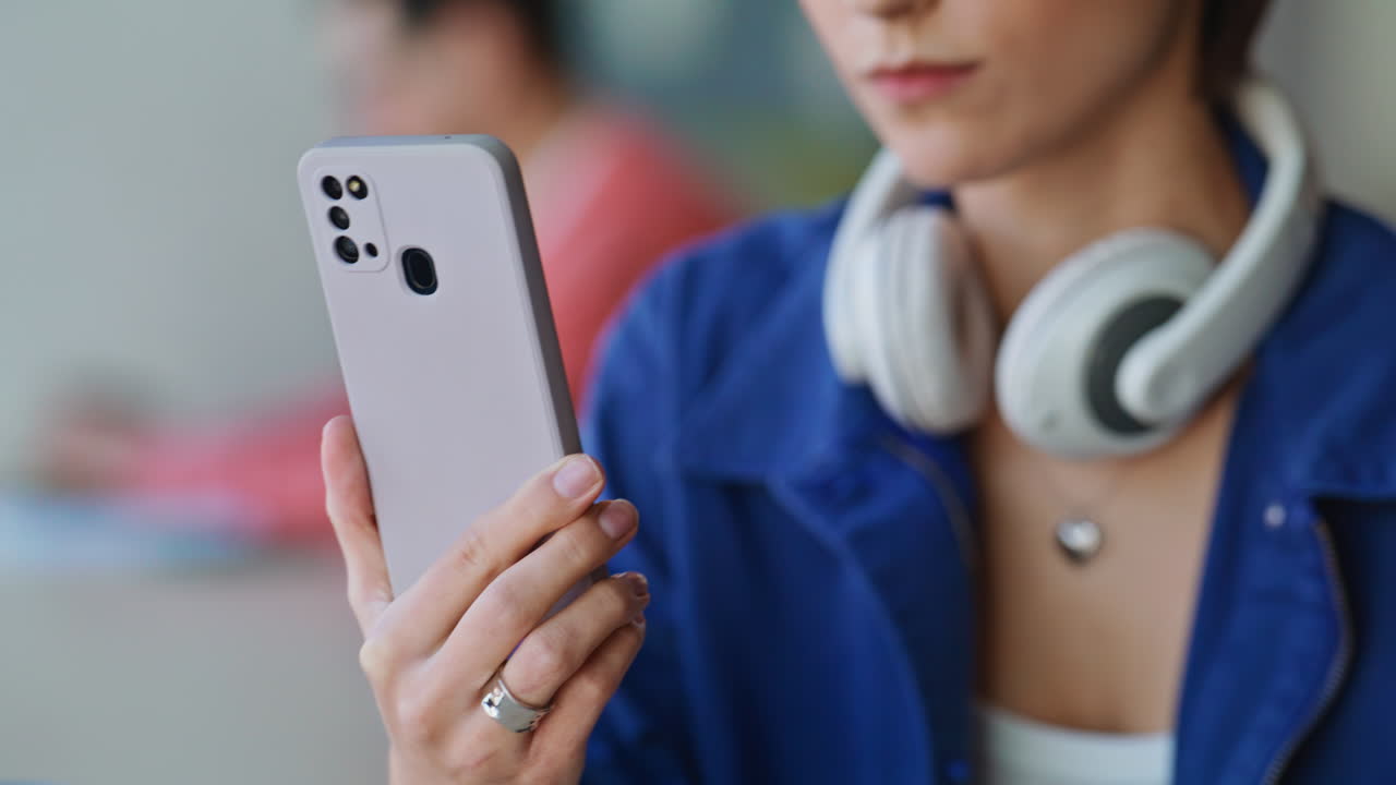 Employee receiving salary notification on cellphone at coworking office closeup