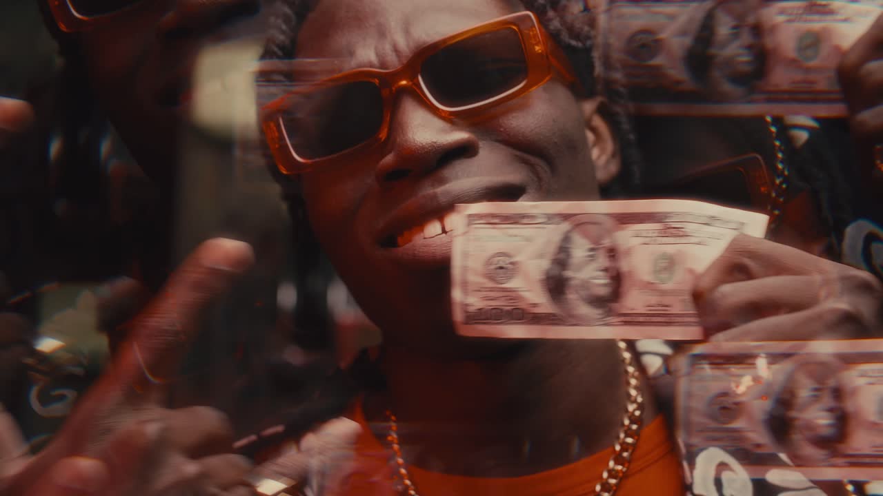 Kaleidoscopic Effect of Cool Black Man in Sunglasses Demonstrating Dollar Bill