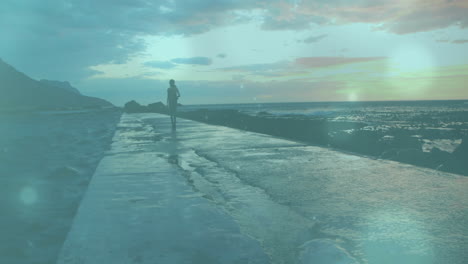 person jogging on wet pathway by ocean, with light effects animation