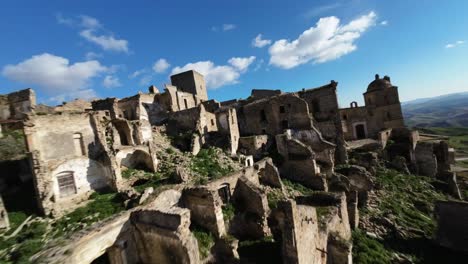 fpv drone flying at high speed just above the dilapidated and abandoned houses of craco, italy